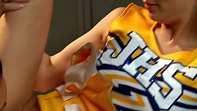 Two charming cheerleaders are moaning while gently eating each other up, in the locker room